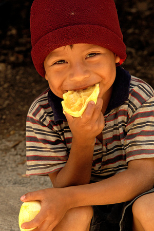 Kirkland a 5 Boy eating an orange Guatemala